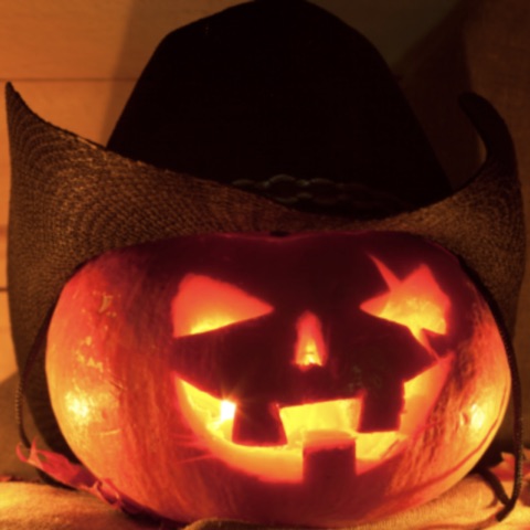 Glowing jack-o-lantern wearing a cowboy hat